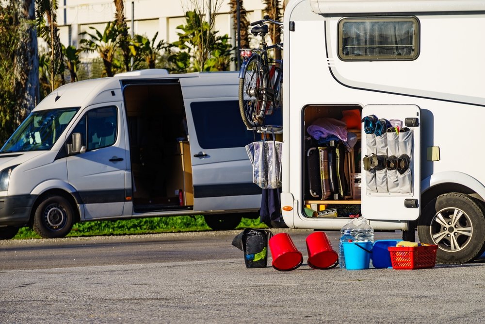 Camper car in maintenance service. Cleaning and preparing motorhome at caravan campsite outside. Holidays with mobilehome.